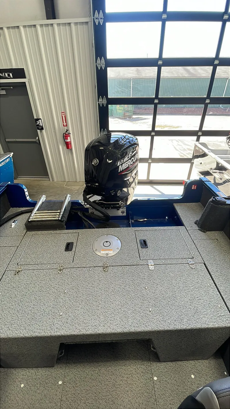 Slide: The Image of 2025 Lund 1650 Rebel XL Sport boat with Mercury outboard motor in showroom. - 12