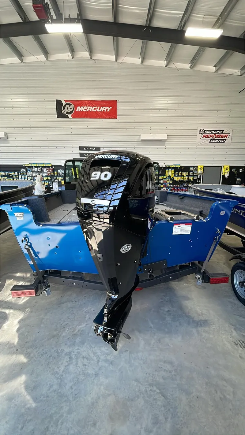 Slide: The Image of 2025 Lund 1650 Rebel XL Sport boat with Mercury 90 engine in showroom. - 4