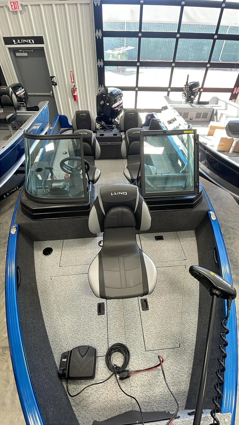 Slide: The Image of 2025 Lund 1650 Rebel XL Sport boat interior with seating and controls. - 8