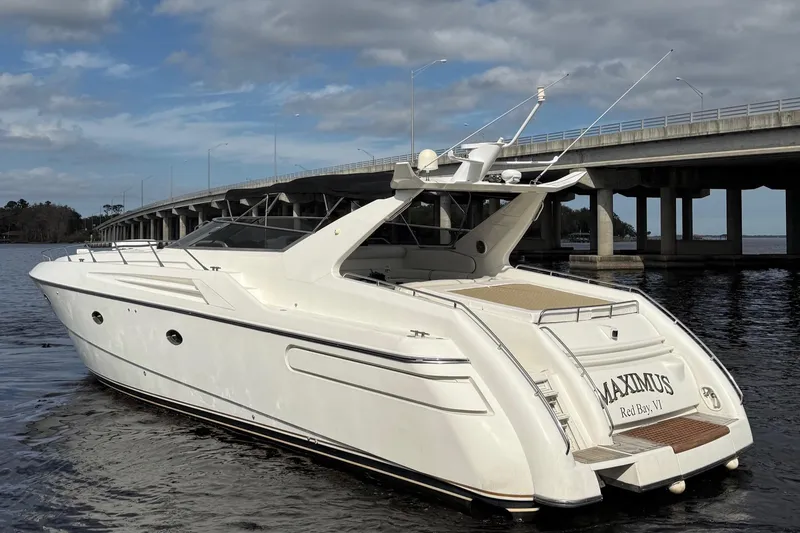 Slide: The Image of 1994 Sunseeker Camargue 55 yacht on water near a bridge, rear view. - 2