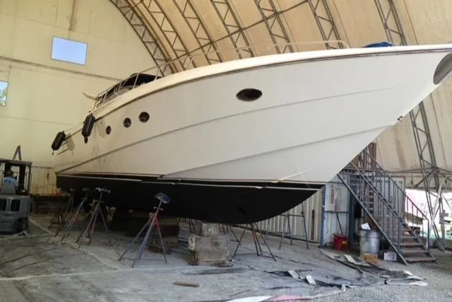 Slide: The Image of 1994 Sunseeker Camargue 55 yacht in dry dock for maintenance inside a large shed. - 22