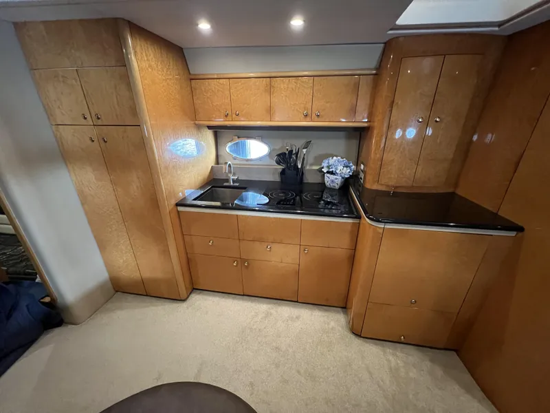 Slide: The Image of Luxurious kitchen interior of 1994 Sunseeker Camargue 55 yacht with wood cabinetry. - 8