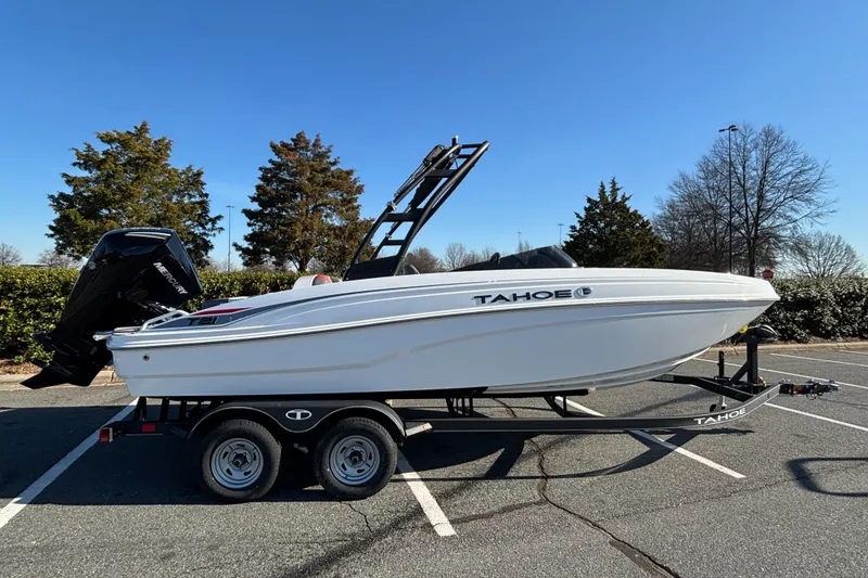 The Image of 2024 Tahoe T21 boat on trailer in parking lot, side view. - 0