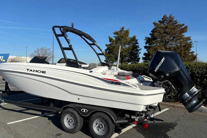 Slide: The Image of 2024 Tahoe T21 boat on trailer with Mercury outboard motor in parking lot. - 5