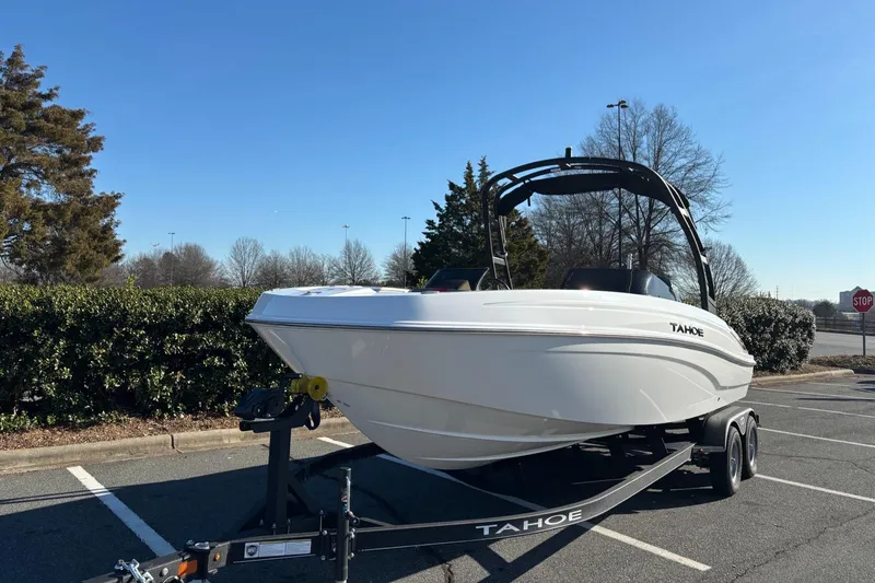Slide: The Image of 2024 Tahoe T21 boat on trailer in parking lot, clear sky background. - 6