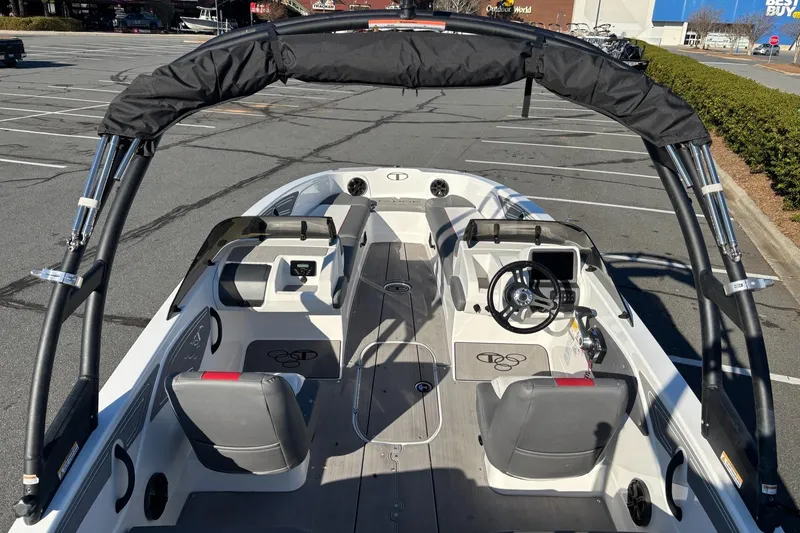 Slide: The Image of 2024 Tahoe T21 boat interior with seating and steering wheel in a parking lot. - 9