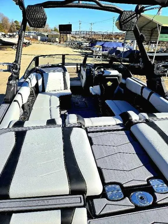 Slide: The Image of 2025 Malibu 22 MXZ boat interior with sleek seating and modern design. - 8