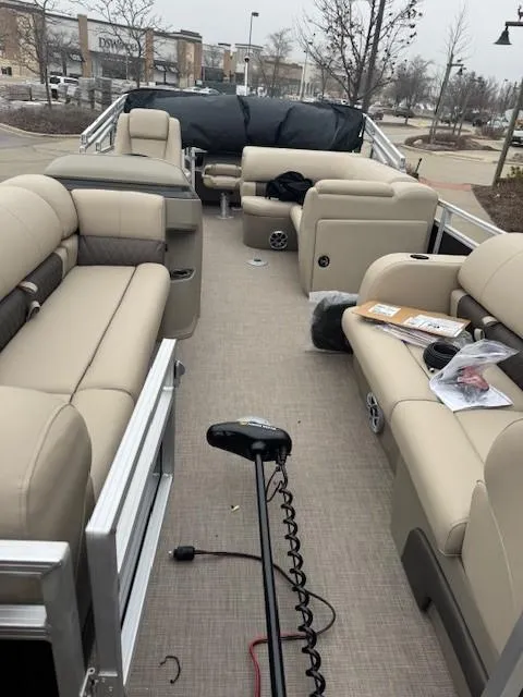 Slide: The Image of 2025 Sun Tracker SportFish 22 DLX pontoon boat with beige seating and fishing gear. - 7