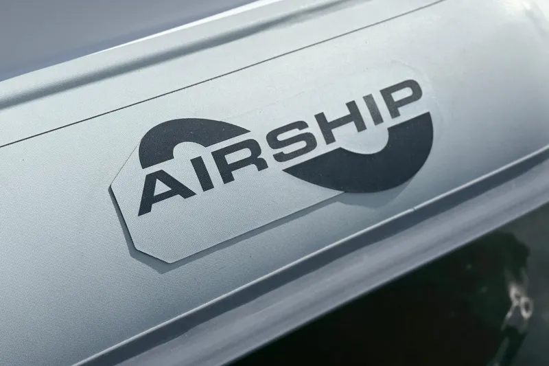 Slide: The Image of Airship 115 logo on sleek metallic surface, 2025 model design. - 11