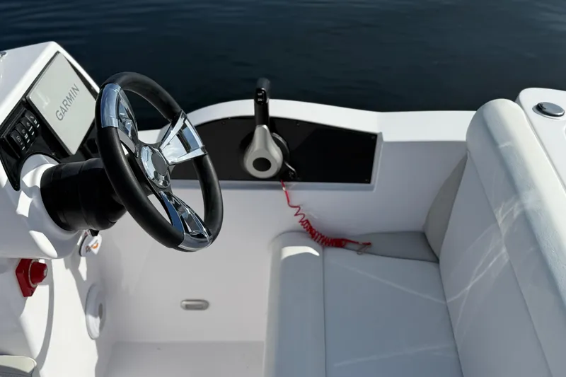 Slide: The Image of Steering wheel and controls of 2025 Airship 115 boat, featuring Garmin navigation system. - 9