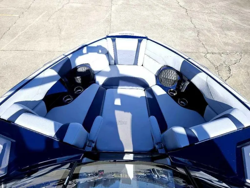 Slide: The Image of 2025 Malibu Wakesetter 23 LSV boat interior with plush seating and cup holders. - 8