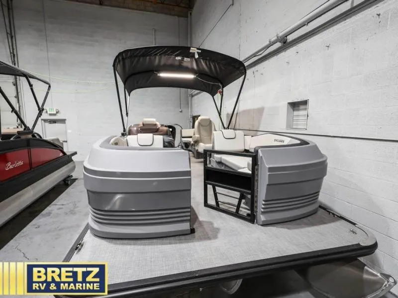 Slide: The Image of 2025 Mirage LZ A-22 SPORT pontoon boat in showroom, featuring sleek design and spacious seating. - 5