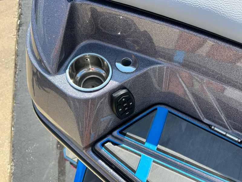 Slide: The Image of 2022 Supra SE boat interior detail with cup holder and control panel. - 10