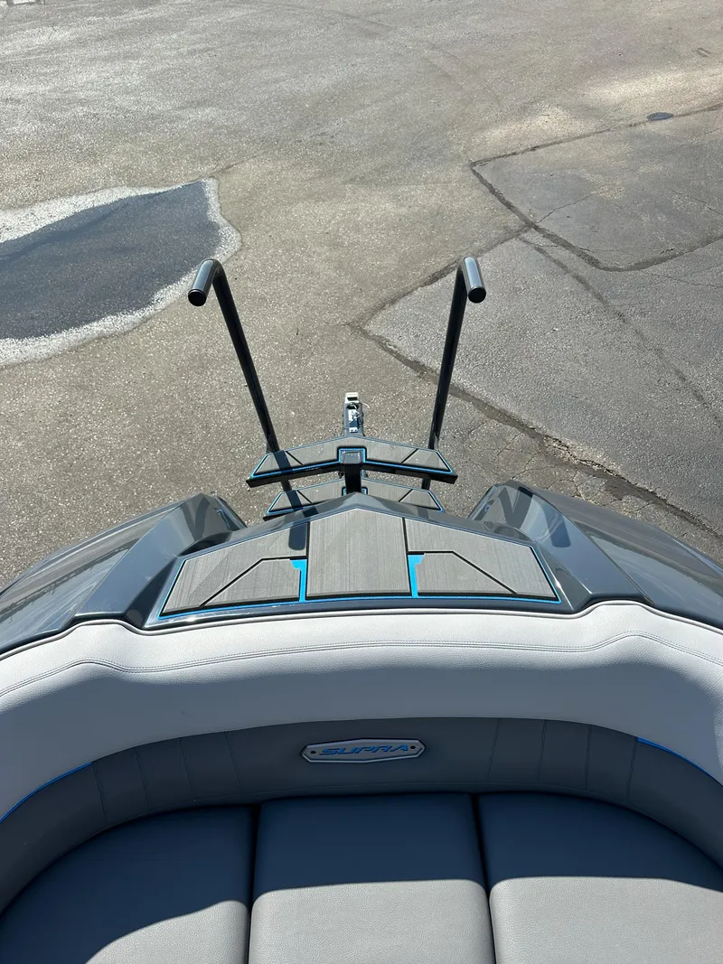 Slide: The Image of 2022 Supra SE boat with sleek design and modern features, docked on a sunny day. - 15