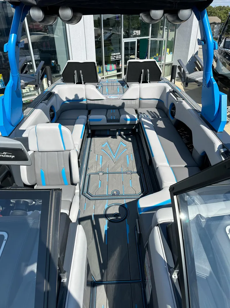Slide: The Image of 2022 Supra SE boat interior with modern seating and blue accents. - 16