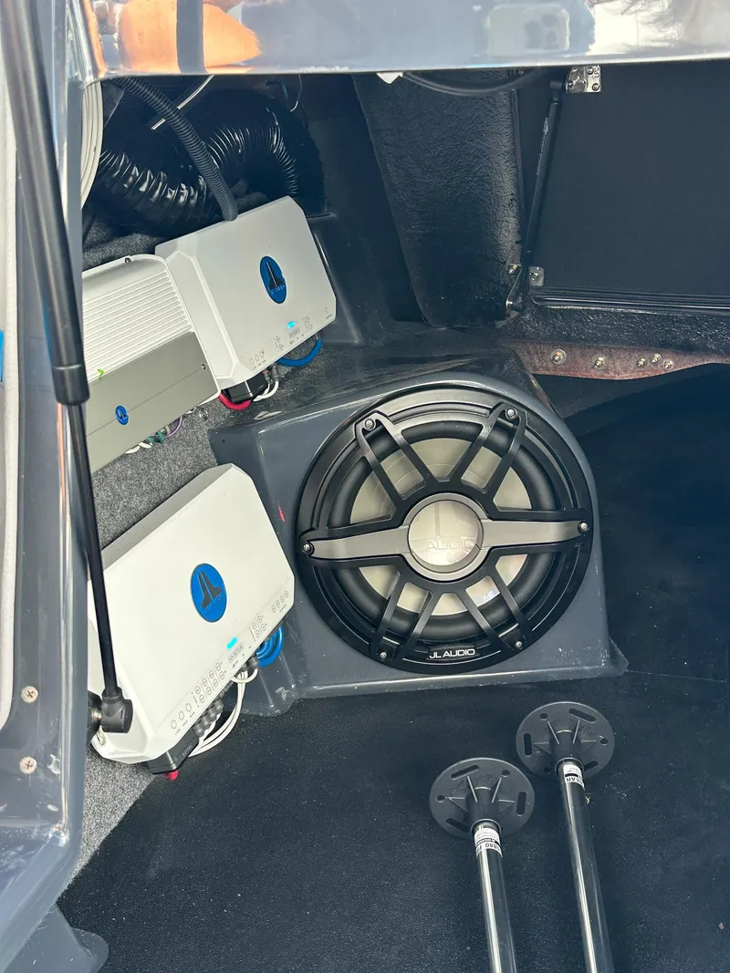 Slide: The Image of 2022 Supra SE audio system with subwoofer and amplifiers in vehicle trunk. - 18