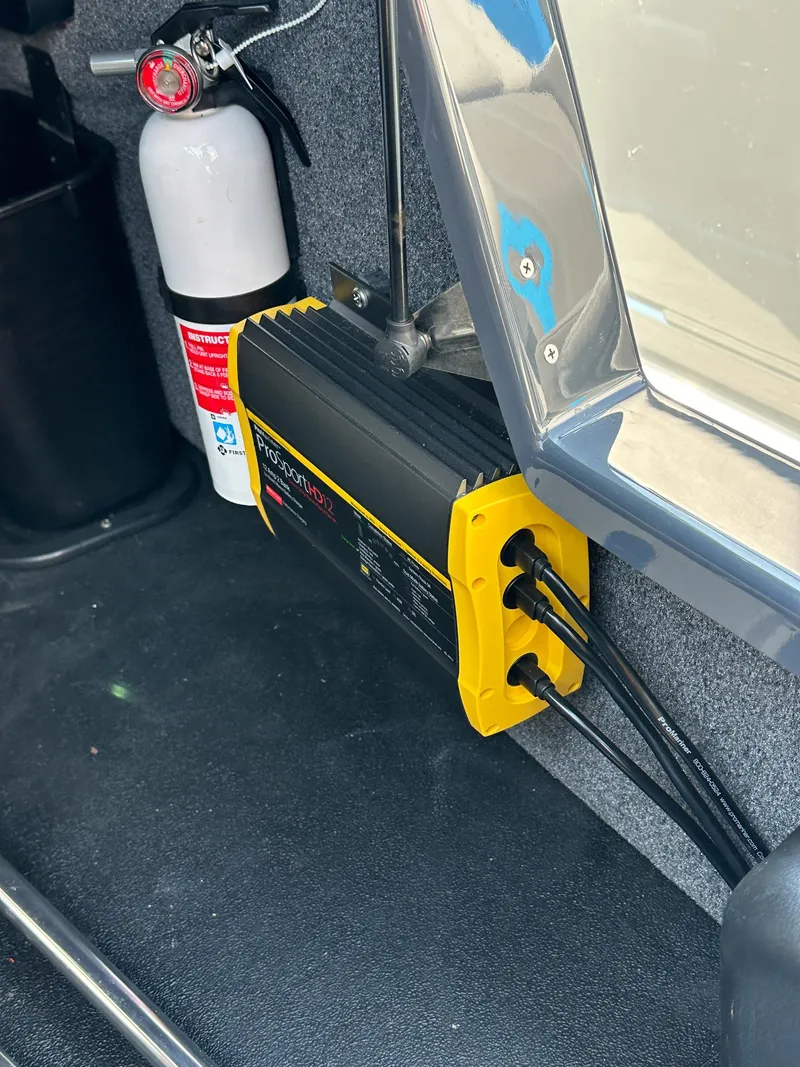 Slide: The Image of 2022 Supra SE interior with mounted fire extinguisher and battery charger. - 19