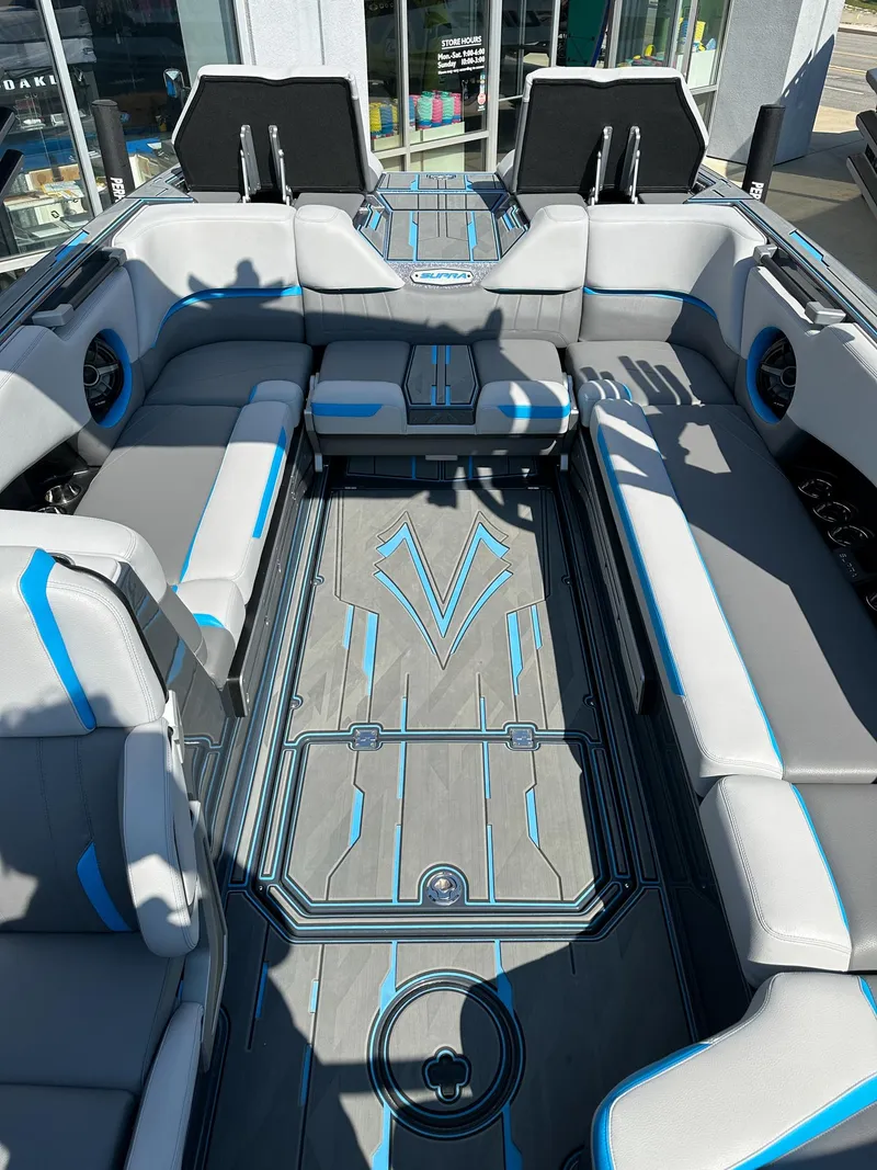 Slide: The Image of 2022 Supra SE boat interior with gray and blue seating, modern design, and spacious layout. - 23