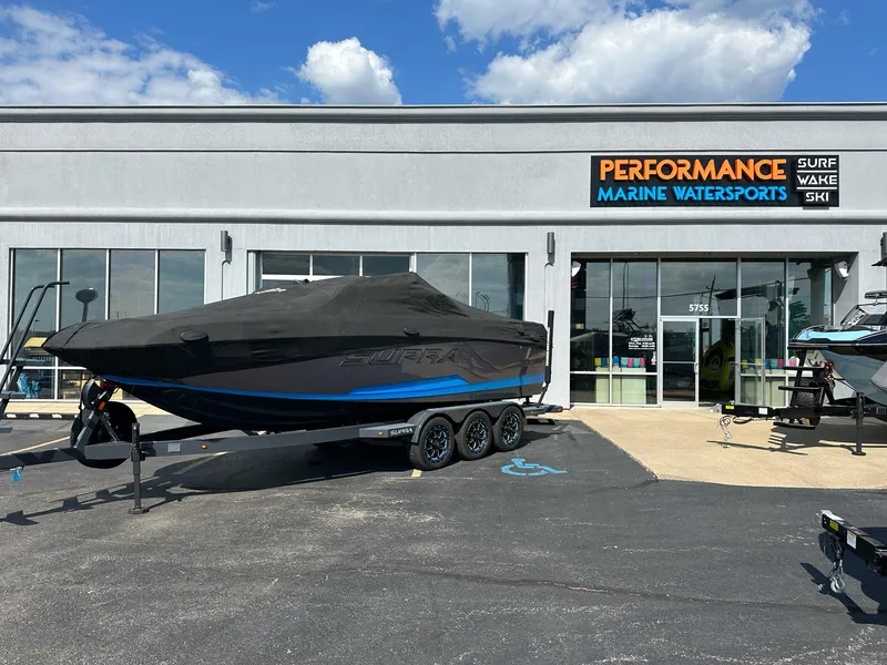 Slide: The Image of 2022 Supra SE boat covered, parked outside Performance Marine Watersports store. - 29