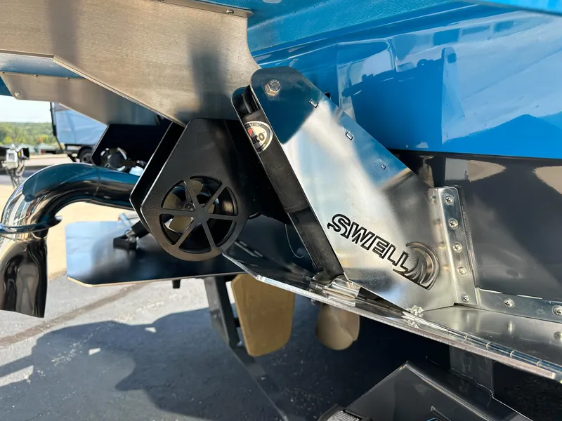 Slide: The Image of Rear view of 2022 Supra SE boat with TSWELL system and blue exterior. - 5