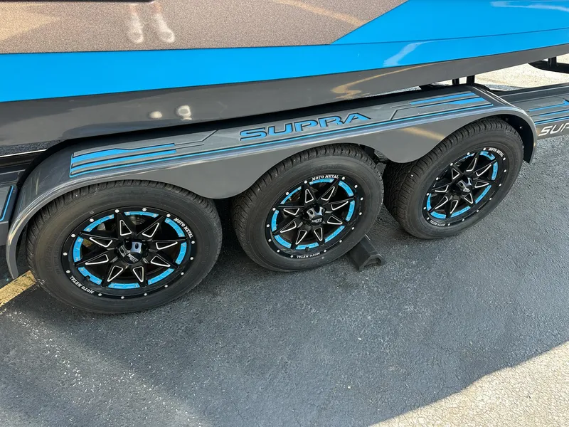 Slide: The Image of 2022 Supra SE trailer with blue-accented wheels and sleek design. - 7