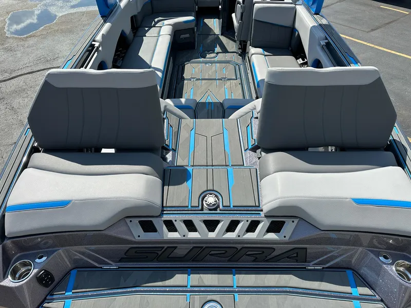 Slide: The Image of 2022 Supra SE boat interior with gray and blue seating, spacious layout. - 9