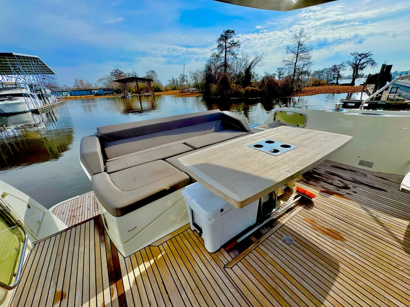 Slide: The Image of Luxurious deck of 2016 Prestige 550 yacht with seating area and table. - 10
