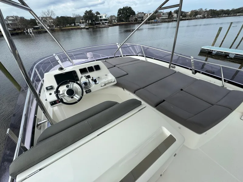 Slide: The Image of 2016 Prestige 550 yacht with spacious deck and helm station. - 16