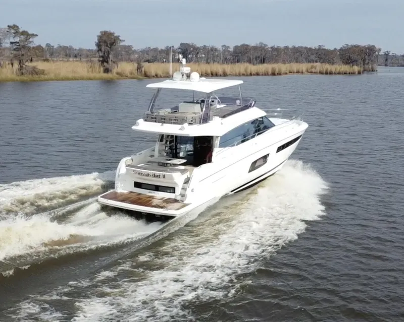 Slide: The Image of 2016 Prestige 550 Yacht cruising on a calm river. - 2