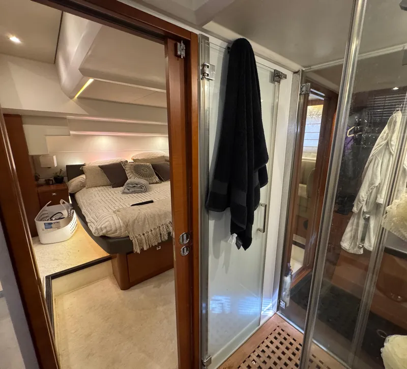 Slide: The Image of Interior of a 2016 Prestige 550 yacht, featuring bedroom and bathroom. - 35