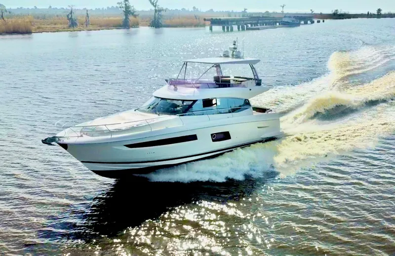 Slide: The Image of 2016 Prestige 550 yacht cruising on a serene river. - 4