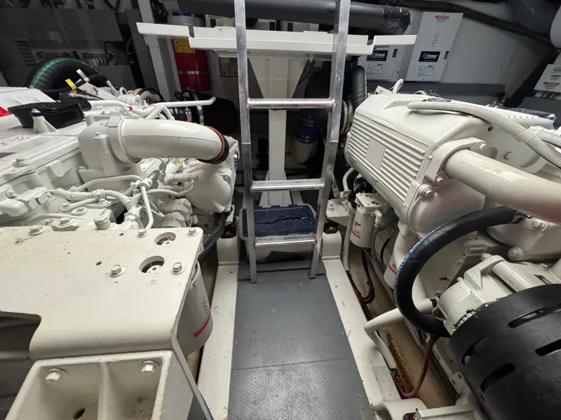 Slide: The Image of Engine room of a 2016 Prestige 550 yacht with ladders and machinery. - 48