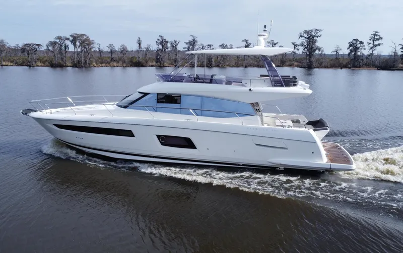 Slide: The Image of 2016 Prestige 550 luxury yacht cruising on a calm river. - 5