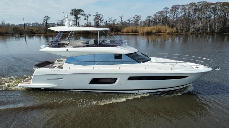 Slide: The Image of 2016 Prestige 550 yacht cruising on a calm river. - 6