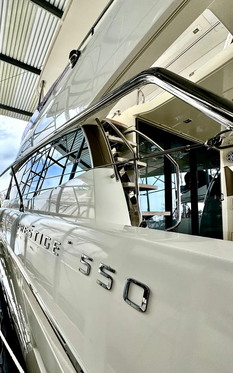 Slide: The Image of 2016 Prestige 550 luxury yacht docked in marina. - 9