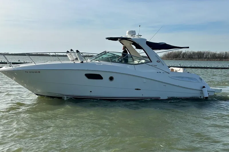 The Image of 2011 Sea Ray 350 Sundancer cruising on a calm lake. - 0