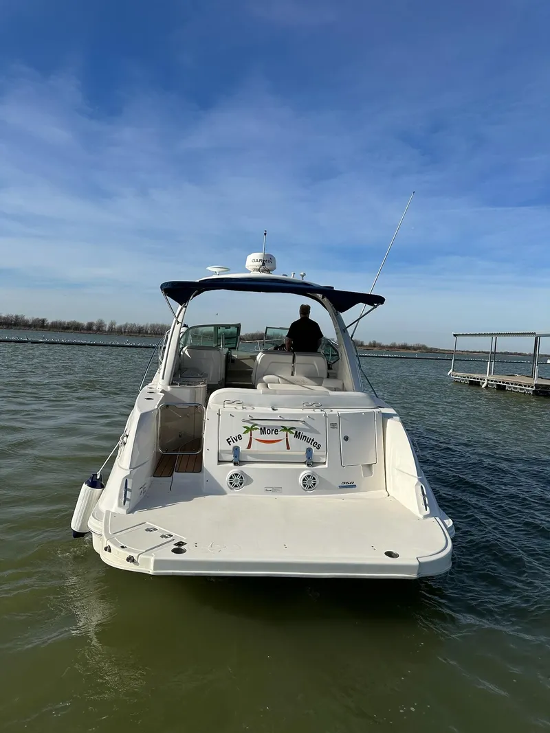 Slide: The Image of 2011 Sea Ray 350 Sundancer boat on calm water, rear view, clear sky. - 14