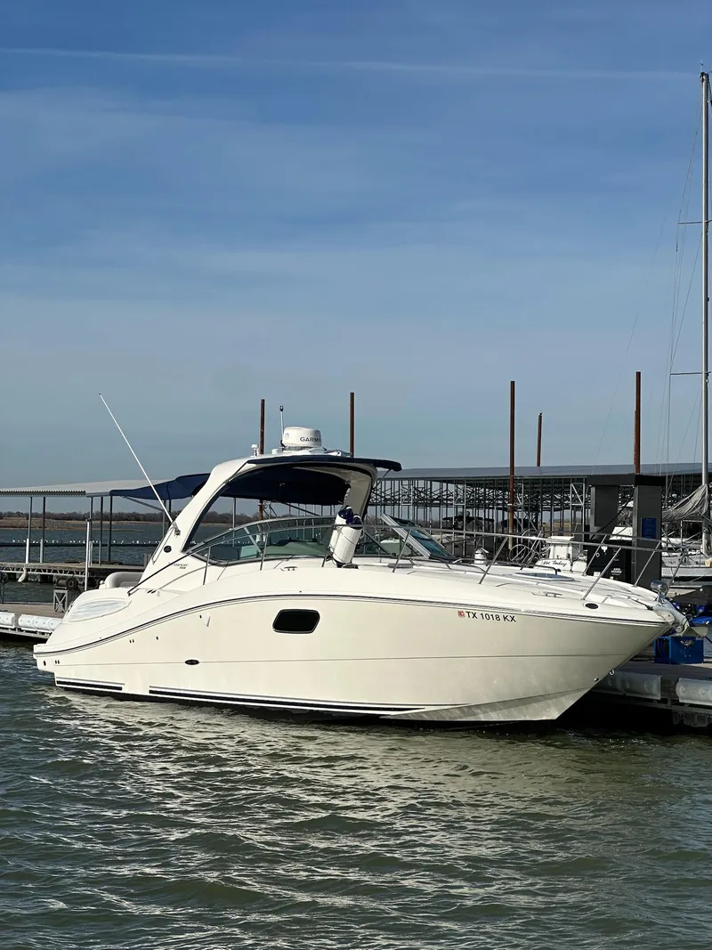 Slide: The Image of 2011 Sea Ray 350 Sundancer yacht docked at marina under clear sky. - 16