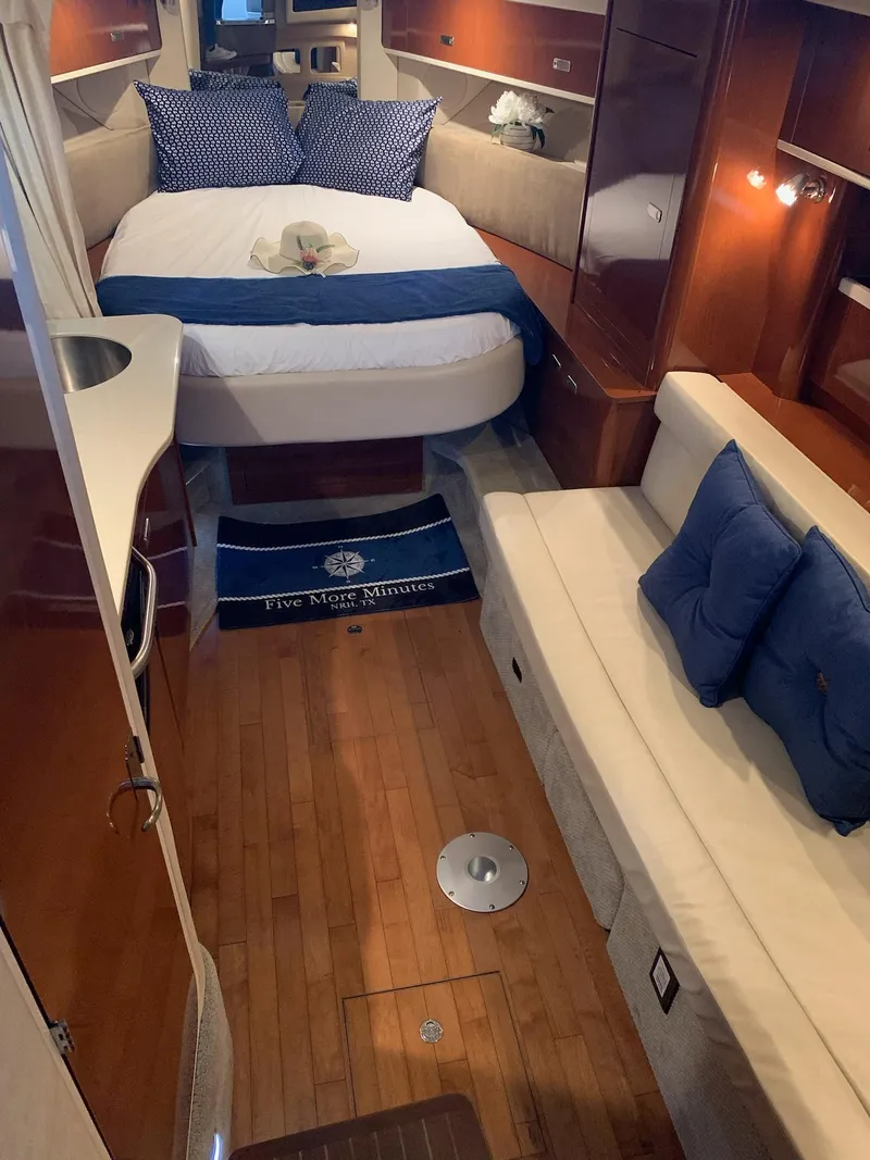 Slide: The Image of Interior of 2011 Sea Ray 350 Sundancer yacht with cozy bed and seating area. - 21
