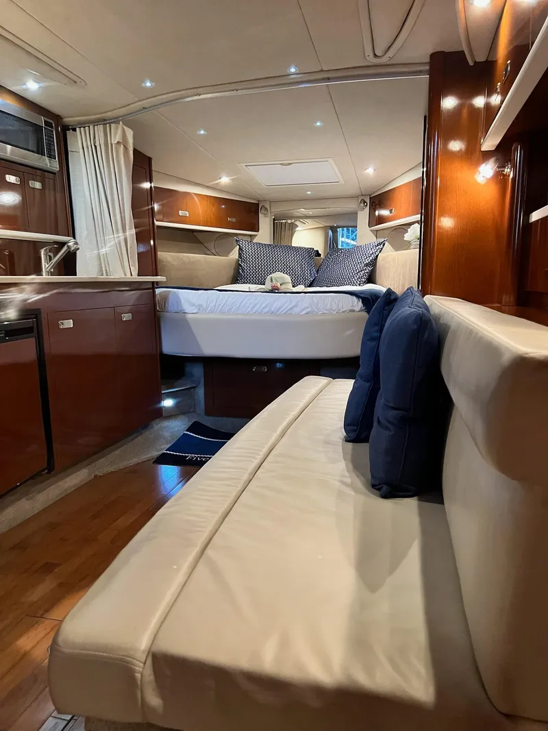 Slide: The Image of Interior of 2011 Sea Ray 350 Sundancer yacht with luxurious seating and bedding. - 22