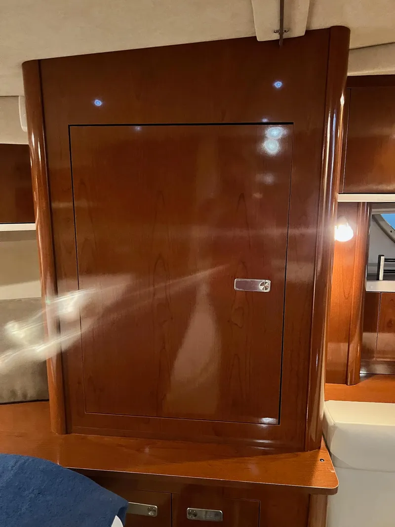 Slide: The Image of Interior of 2011 Sea Ray 350 Sundancer with wooden cabinetry and ambient lighting. - 25