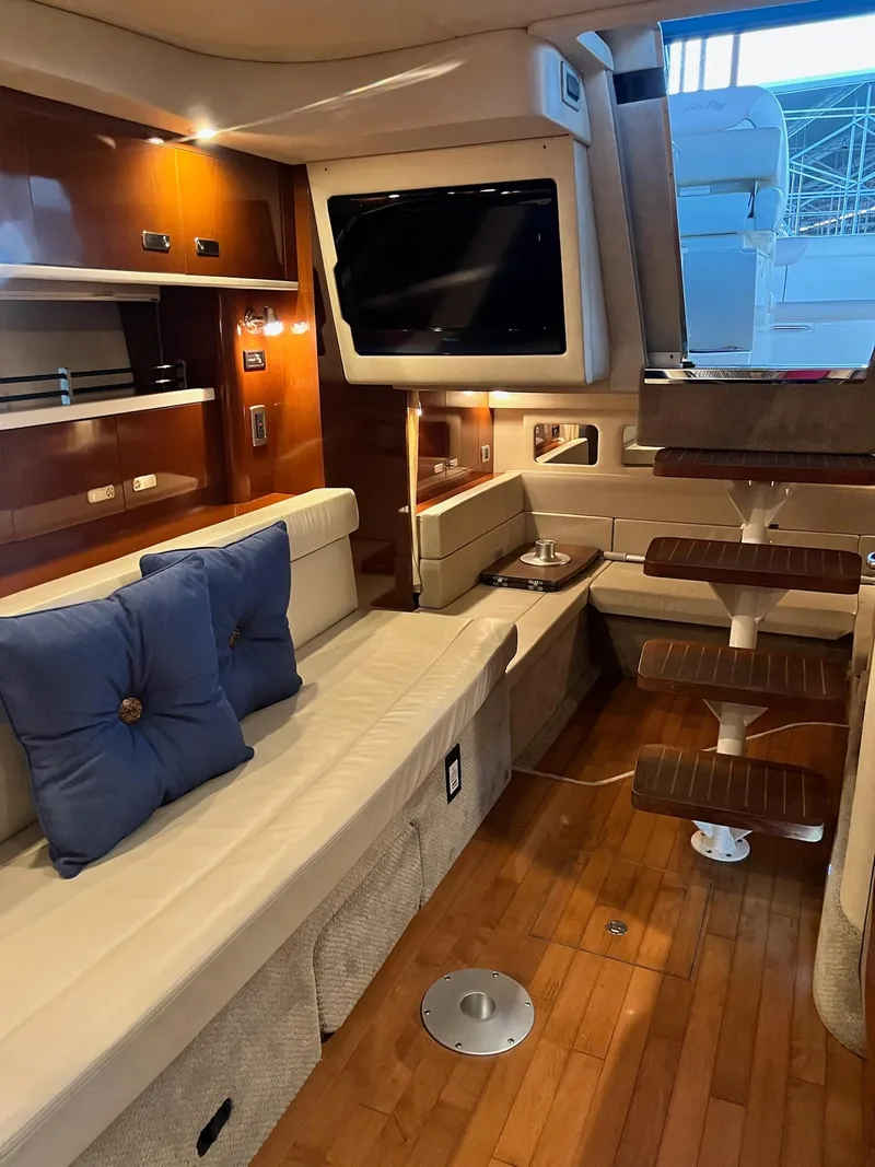 Slide: The Image of Interior of 2011 Sea Ray 350 Sundancer yacht with modern seating and wooden flooring. - 27