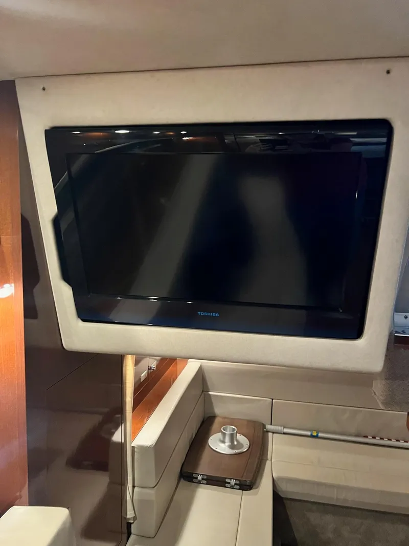 Slide: The Image of Interior of a 2011 Sea Ray 350 Sundancer featuring a mounted flat-screen TV. - 30