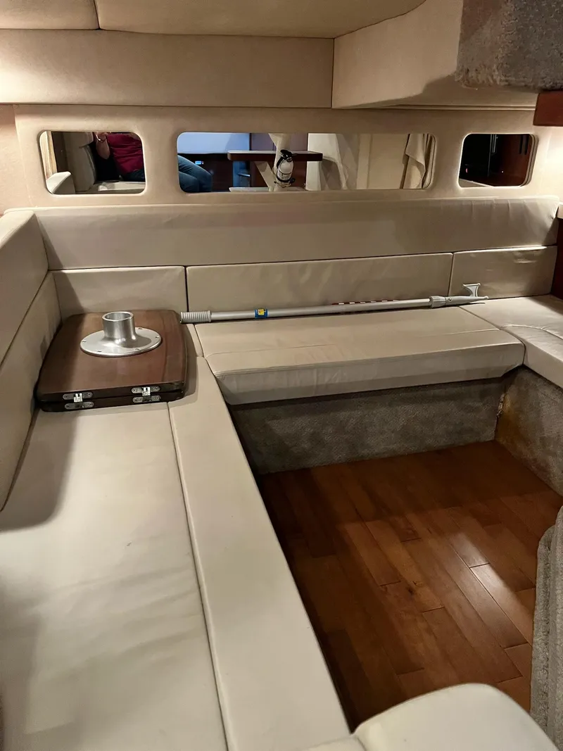 Slide: The Image of Interior of 2011 Sea Ray 350 Sundancer with beige seating and wooden flooring. - 34