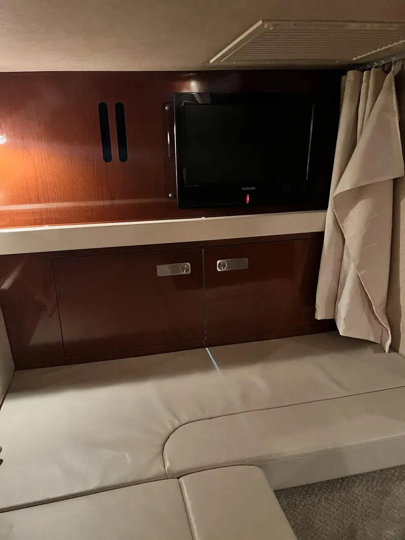 Slide: The Image of Interior of 2011 Sea Ray 350 Sundancer with TV and wood paneling. - 38