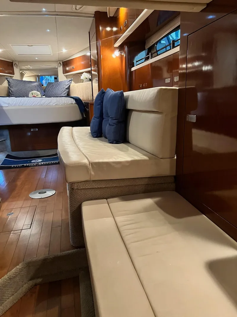 Slide: The Image of Interior of 2011 Sea Ray 350 Sundancer yacht with elegant seating and wooden flooring. - 39