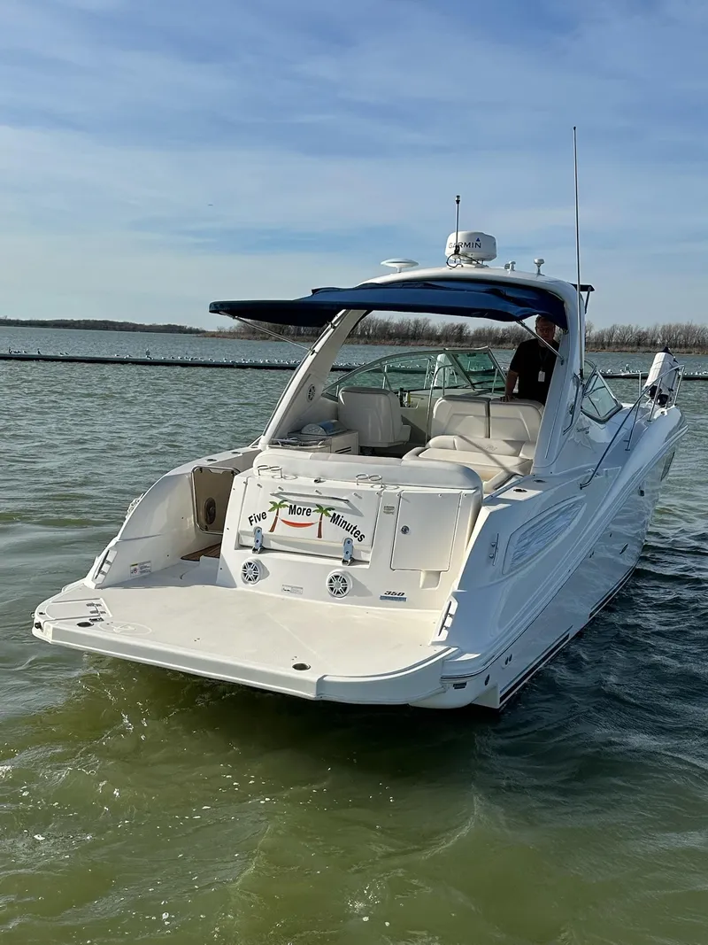 Slide: The Image of 2011 Sea Ray 350 Sundancer cruising on calm waters under a clear sky. - 4