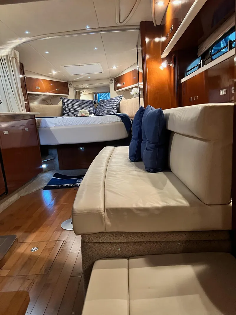 Slide: The Image of Interior of a 2011 Sea Ray 350 Sundancer yacht with elegant wood finishes and cozy seating. - 40
