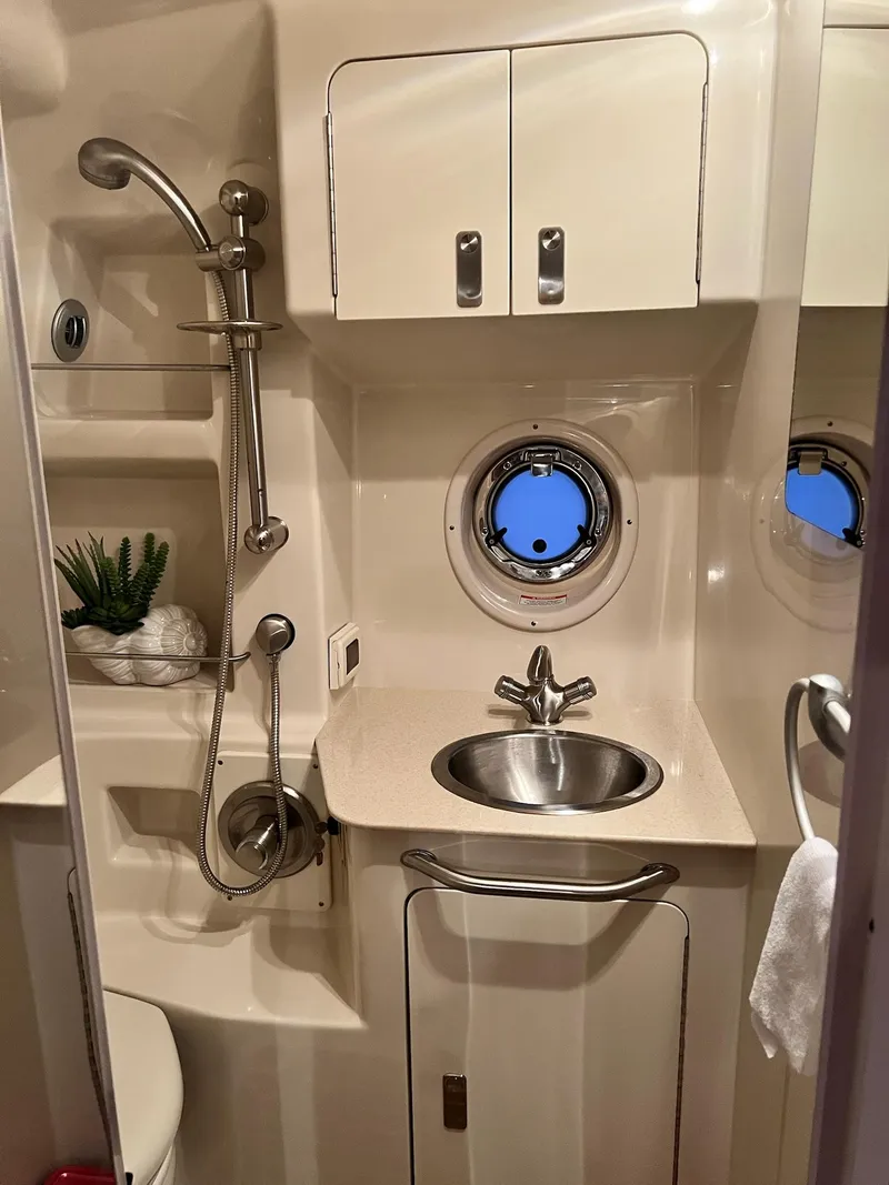 Slide: The Image of 2011 Sea Ray 350 Sundancer bathroom with sink, shower, and porthole window. - 44
