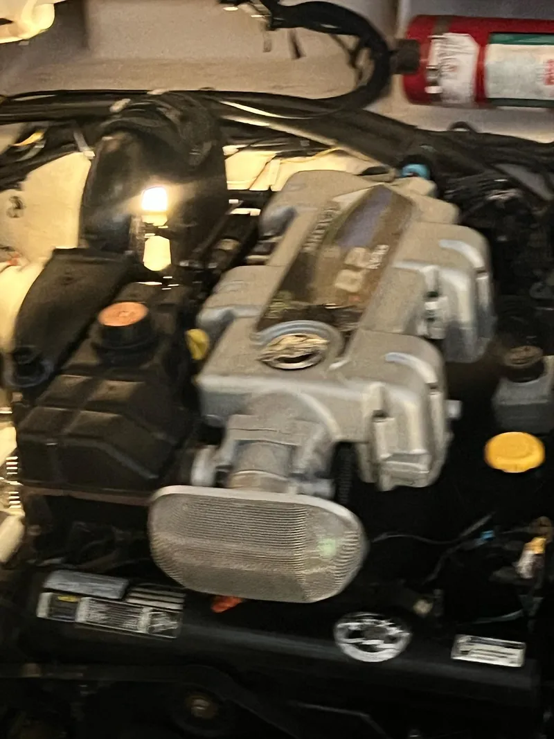 Slide: The Image of Engine of a 2011 Sea Ray 350 Sundancer boat, featuring various components and a fire extinguisher. - 47